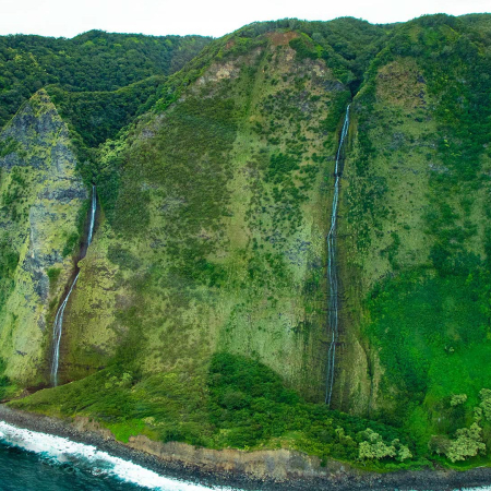 flying over the verdant rainforest and cascading waterfalls big island helicopter experience product images
