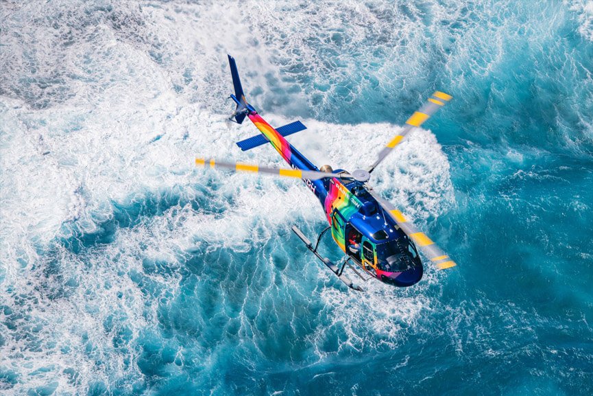 the helicopter hugs the coast of the famed north shore on the rainbow helicopters oahu hawaii