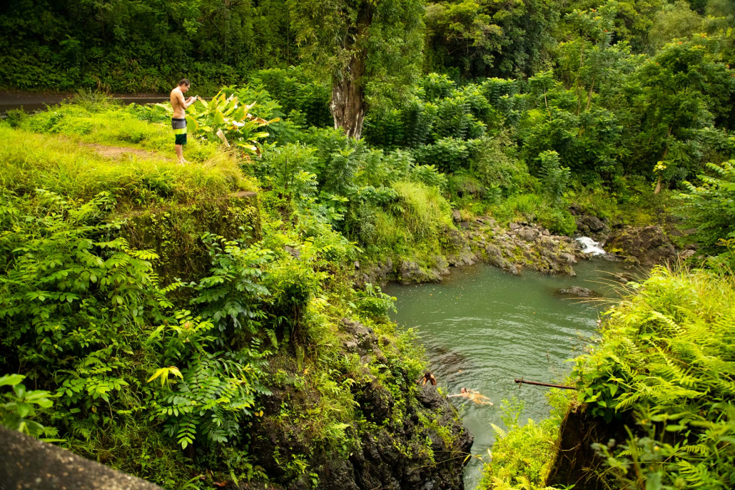 visitors swimming at keanae waterfalls in the island of maui